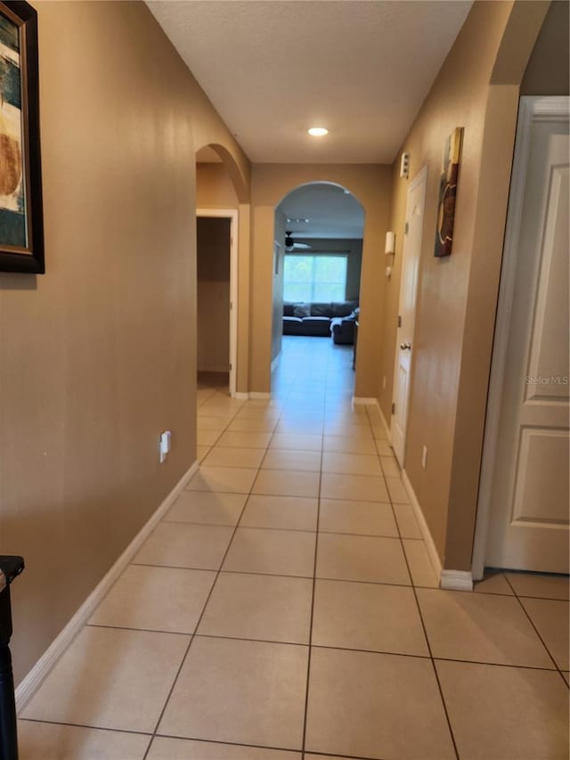 144 Hawthorne Way, Davenport, FL 33896 - corridor featuring light tile patterned floors, arched walkways, and recessed lighting