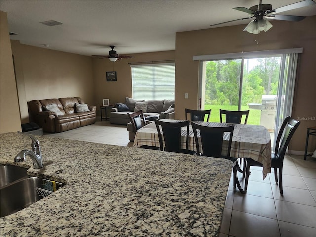 144 Hawthorne Way, Davenport, FL 33896 - dining space with ceiling fan and light tile patterned flooring