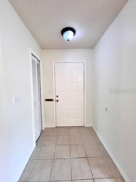 812 10th St, Saint Cloud, FL 34769 - doorway featuring light tile patterned floors and baseboards