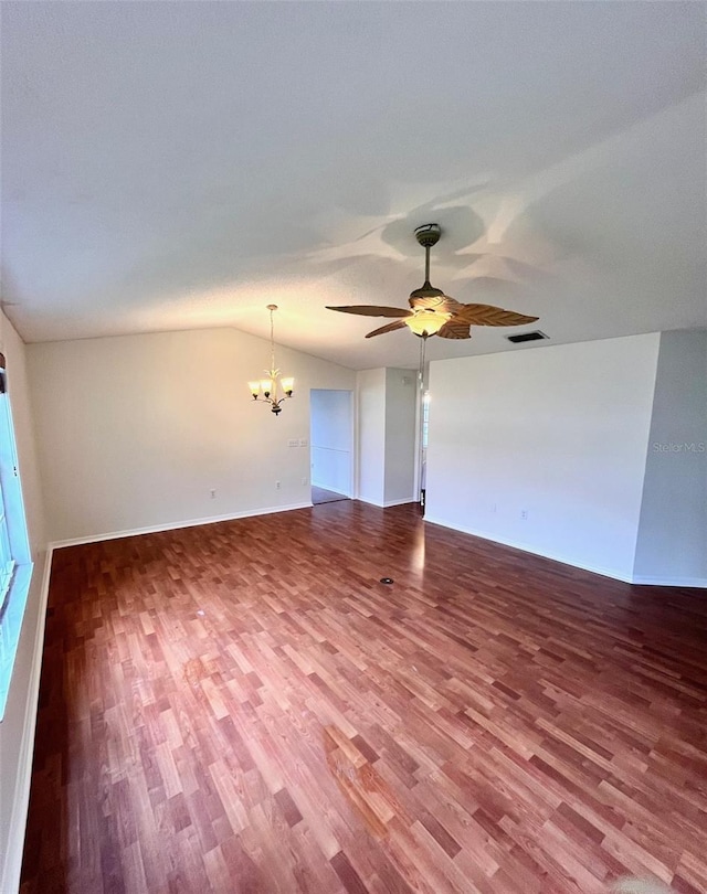 812 10th St, Saint Cloud, FL 34769 - spare room with a chandelier, wood finished floors, a ceiling fan, and vaulted ceiling