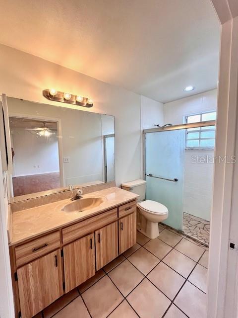 812 10th St, Saint Cloud, FL 34769 - bathroom featuring vanity, a stall shower, and tile patterned floors