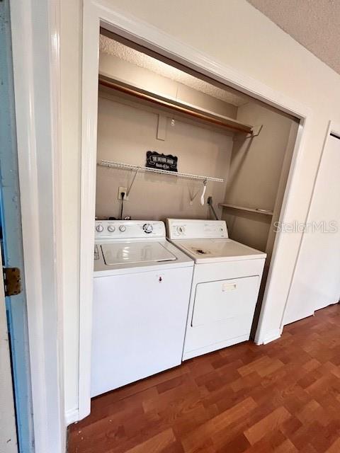 812 10th St, Saint Cloud, FL 34769 - washroom featuring washer and dryer and wood finished floors