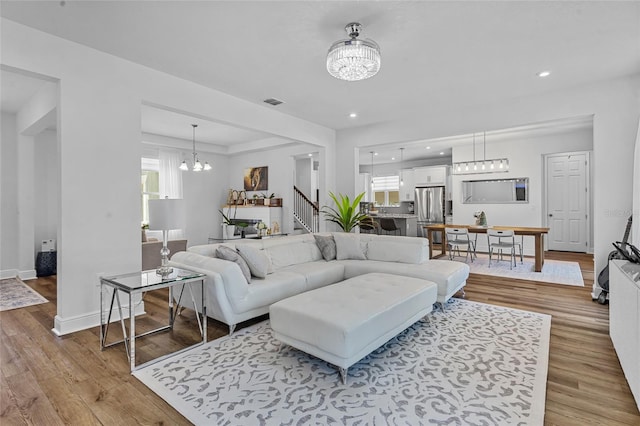 3252 Jackson Bluff Way, Clermont, FL 34711 - living area with a chandelier, light wood-type flooring, recessed lighting, and stairs