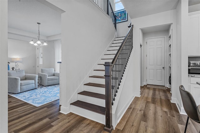 3252 Jackson Bluff Way, Clermont, FL 34711 - stairway with wood finished floors and a chandelier