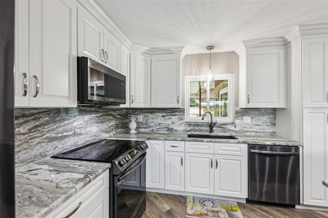 27805 Lois Dr, Tavares, FL 32778 - kitchen with stainless steel appliances, white cabinets, backsplash, and light stone countertops