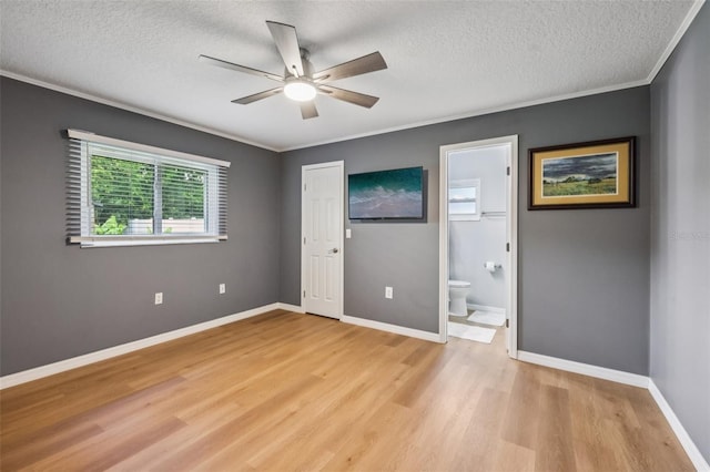 27805 Lois Dr, Tavares, FL 32778 - unfurnished bedroom with light wood-style floors, a textured ceiling, crown molding, connected bathroom, and a ceiling fan