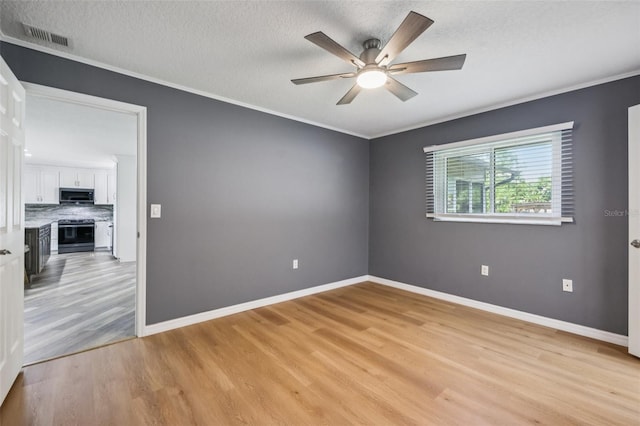 27805 Lois Dr, Tavares, FL 32778 - unfurnished room with light wood finished floors, a ceiling fan, crown molding, and a textured ceiling