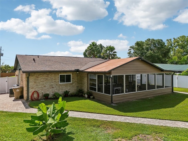 27805 Lois Dr, Tavares, FL 32778 - back of property featuring a sunroom, brick siding, roof with shingles, and a patio area
