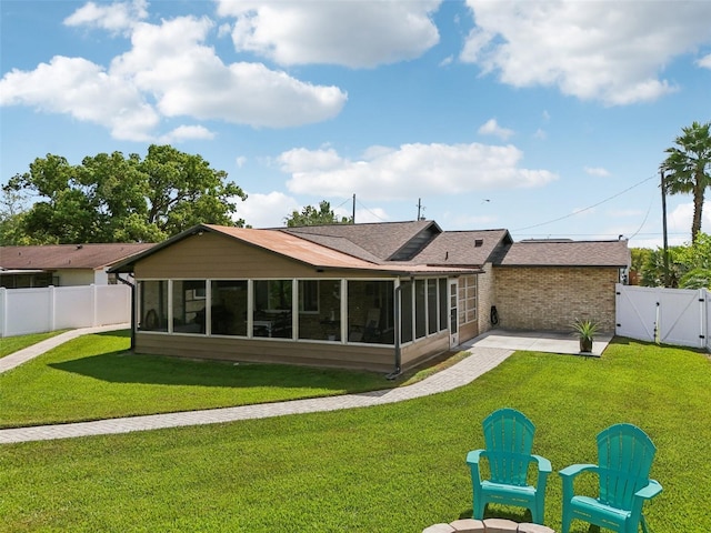 27805 Lois Dr, Tavares, FL 32778 - rear view of house featuring a sunroom, a gate, a fenced backyard, a patio, and roof with shingles