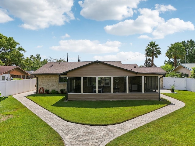 27805 Lois Dr, Tavares, FL 32778 - rear view of house featuring a sunroom, a gate, a fenced backyard, and brick siding