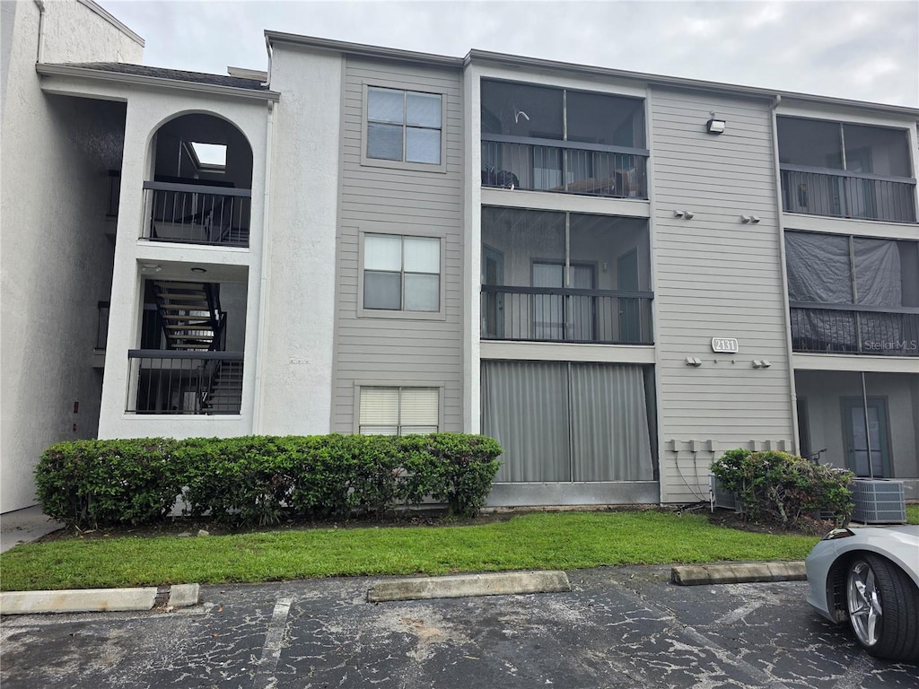 2131 Cascades Blvd Unit 103, Kissimmee, FL 34741 - view of property featuring uncovered parking
