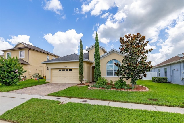 2823 Sail Breeze Way, Kissimmee, FL 34744 - view of front of home with a garage, driveway, stucco siding, and a front lawn