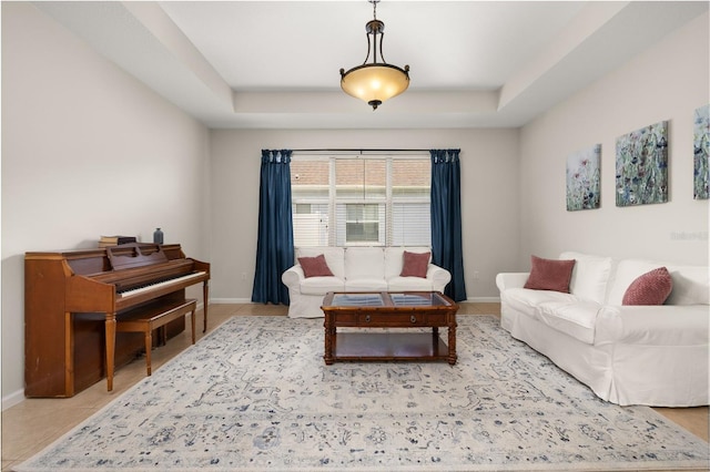 2823 Sail Breeze Way, Kissimmee, FL 34744 - living area with a tray ceiling and baseboards