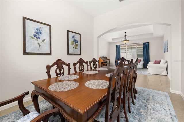 2823 Sail Breeze Way, Kissimmee, FL 34744 - tiled dining area featuring arched walkways and a tray ceiling