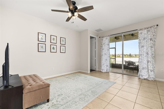 2823 Sail Breeze Way, Kissimmee, FL 34744 - living area featuring light tile patterned floors, a ceiling fan, and a water view