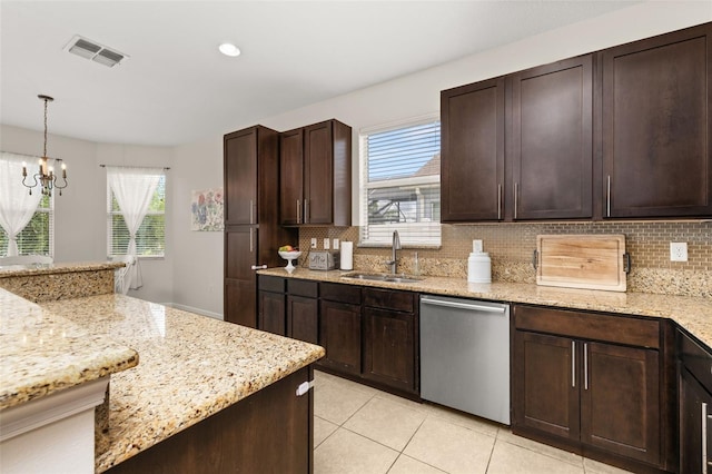 2823 Sail Breeze Way, Kissimmee, FL 34744 - kitchen with stainless steel dishwasher, healthy amount of natural light, decorative backsplash, light tile patterned floors, and recessed lighting