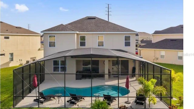 2231 Crofton Springs Ct, Davenport, FL 33837 - rear view of property featuring a patio, a lanai, an outdoor pool, and roof with shingles