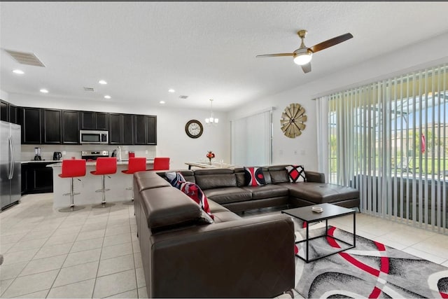 2231 Crofton Springs Ct, Davenport, FL 33837 - living area featuring light tile patterned flooring, a chandelier, recessed lighting, a ceiling fan, and a textured ceiling