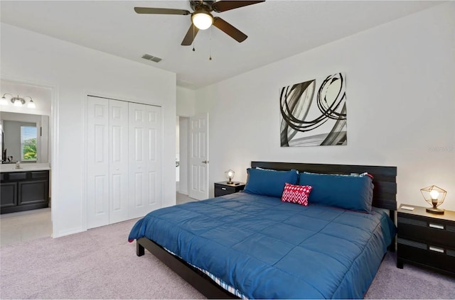 2231 Crofton Springs Ct, Davenport, FL 33837 - bedroom featuring light colored carpet, a closet, connected bathroom, and a ceiling fan