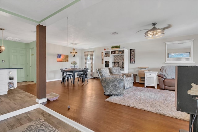 1203 Monterey Dr, Eustis, FL 32726 - living room featuring wood finished floors and a chandelier