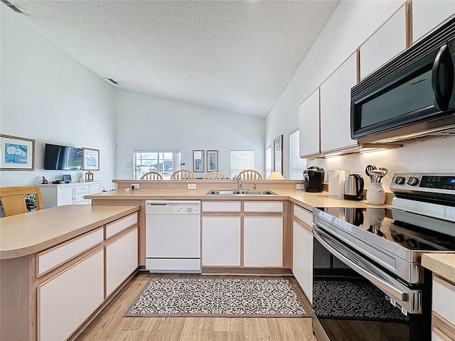 344 Bloomingdale Dr, Davenport, FL 33897 - kitchen featuring white dishwasher, stainless steel range with electric cooktop, black microwave, a peninsula, and light wood-style floors