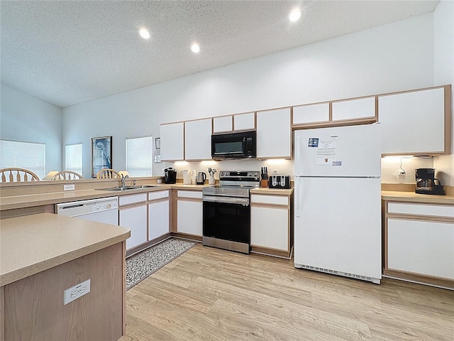 344 Bloomingdale Dr, Davenport, FL 33897 - kitchen with white appliances, light countertops, light wood-type flooring, white cabinets, and recessed lighting