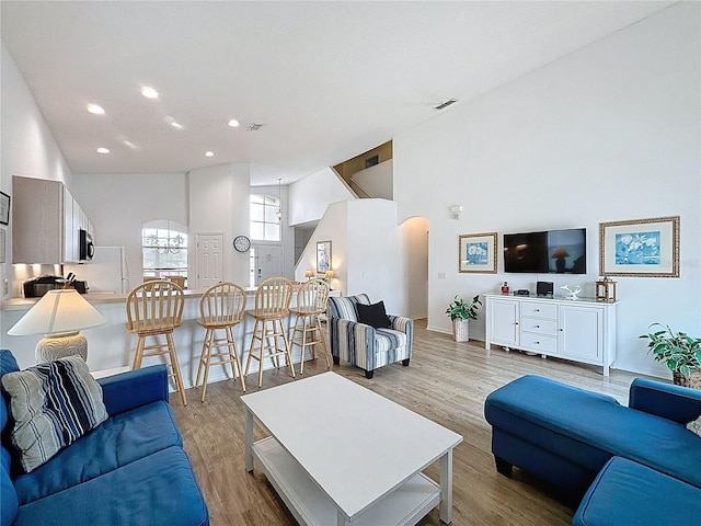 344 Bloomingdale Dr, Davenport, FL 33897 - living room featuring arched walkways, light wood-style flooring, and recessed lighting