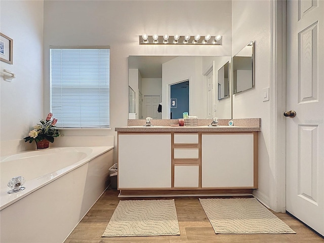 344 Bloomingdale Dr, Davenport, FL 33897 - bathroom with double vanity, wood finished floors, a bath, and an enclosed shower