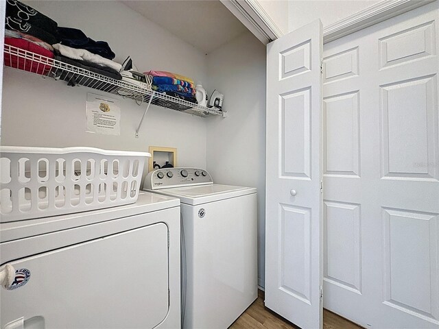 344 Bloomingdale Dr, Davenport, FL 33897 - laundry room with separate washer and dryer and wood finished floors