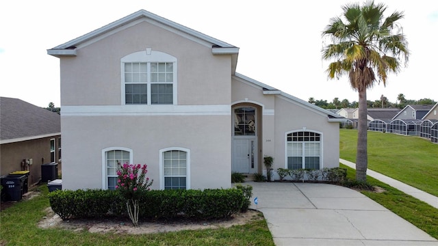 344 Bloomingdale Dr, Davenport, FL 33897 - traditional-style house with a front lawn and stucco siding