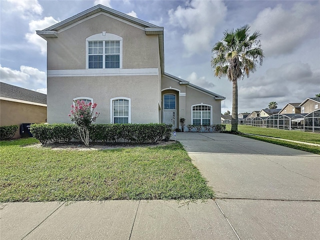 344 Bloomingdale Dr, Davenport, FL 33897 - traditional-style home featuring a front yard, stucco siding, and concrete driveway