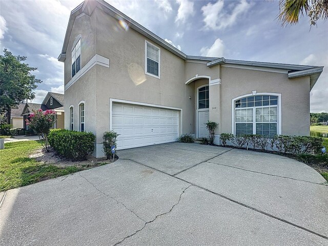 344 Bloomingdale Dr, Davenport, FL 33897 - view of front of property featuring stucco siding, concrete driveway, and an attached garage