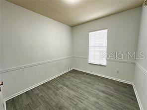 3351 Whitestone Cir Unit 204, Kissimmee, FL 34741 - unfurnished room with baseboards and wood finished floors
