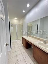 3351 Whitestone Cir Unit 204, Kissimmee, FL 34741 - full bath with double vanity, a shower stall, tile patterned flooring, and recessed lighting