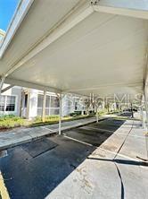 3351 Whitestone Cir Unit 204, Kissimmee, FL 34741 - view of car parking featuring a carport