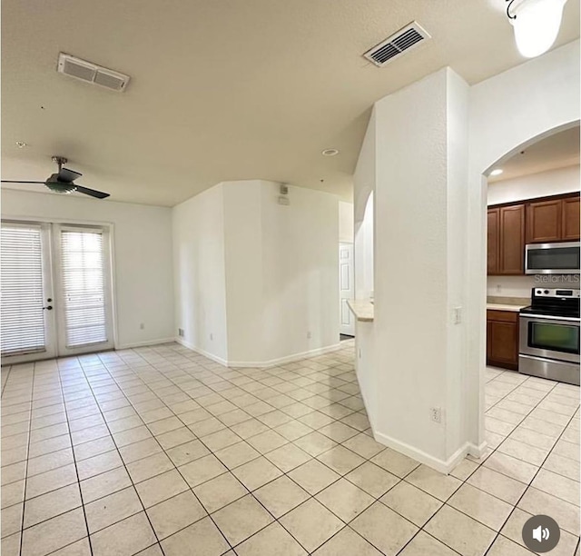 3351 Whitestone Cir Unit 204, Kissimmee, FL 34741 - unfurnished living room featuring light tile patterned floors, arched walkways, a ceiling fan, and french doors