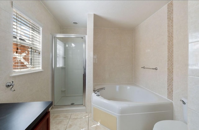 877 Scrub Jay Way, Davenport, FL 33896 - bathroom with a bath, a stall shower, tile patterned floors, vanity, and tile walls