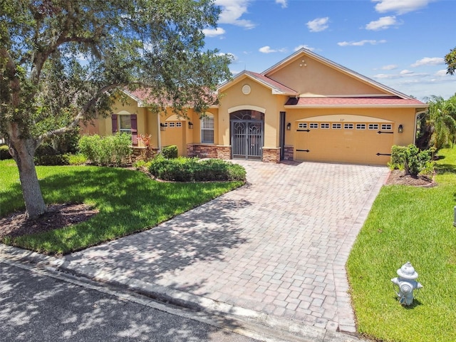 217 Sorrento Rd, Poinciana, FL 34759 - view of front of house with an attached garage, driveway, stucco siding, a front lawn, and stone siding