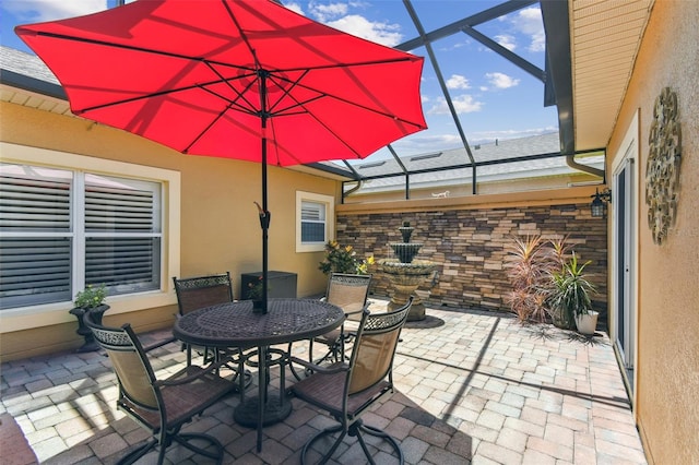 217 Sorrento Rd, Poinciana, FL 34759 - view of patio / terrace featuring glass enclosure and outdoor dining area
