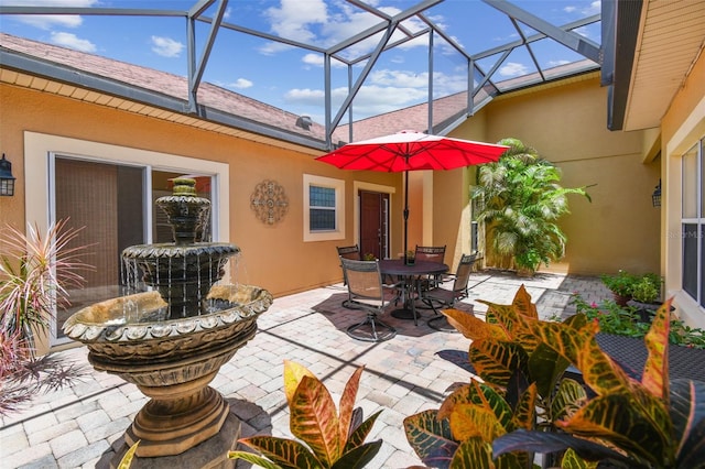 217 Sorrento Rd, Poinciana, FL 34759 - view of patio / terrace featuring outdoor dining area and glass enclosure