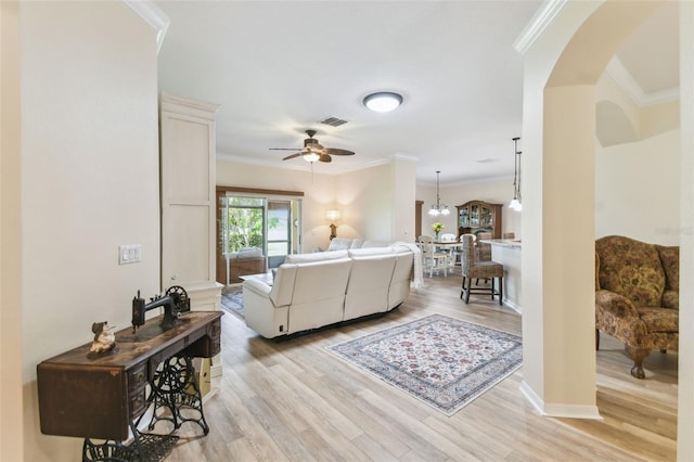 217 Sorrento Rd, Poinciana, FL 34759 - living area with arched walkways, ornamental molding, ceiling fan, and light wood-style floors
