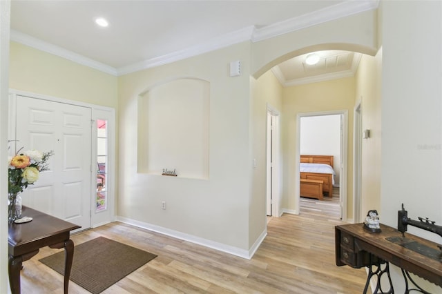 217 Sorrento Rd, Poinciana, FL 34759 - entryway featuring arched walkways, light wood-style flooring, crown molding, and recessed lighting