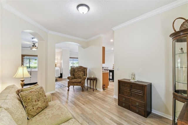 217 Sorrento Rd, Poinciana, FL 34759 - sitting room with light wood finished floors, ornamental molding, arched walkways, and ceiling fan