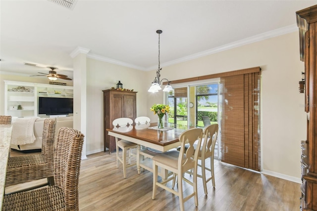217 Sorrento Rd, Poinciana, FL 34759 - dining room with light wood-style flooring, ceiling fan, and ornamental molding
