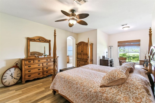 217 Sorrento Rd, Poinciana, FL 34759 - bedroom featuring light wood-style flooring, arched walkways, access to outside, and a ceiling fan