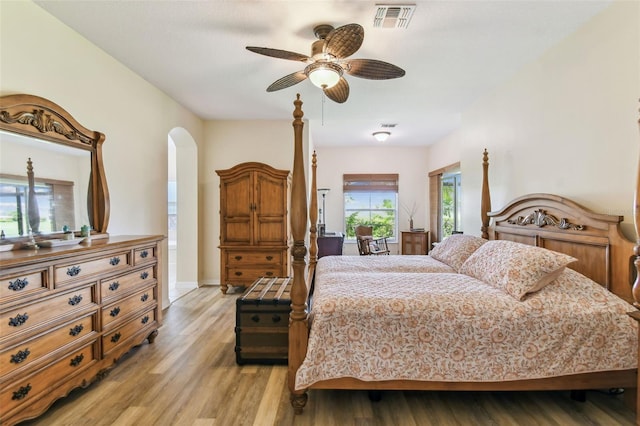 217 Sorrento Rd, Poinciana, FL 34759 - bedroom with arched walkways, light wood finished floors, and a ceiling fan
