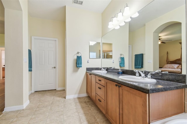 217 Sorrento Rd, Poinciana, FL 34759 - ensuite bathroom with ceiling fan, double vanity, and tile patterned flooring