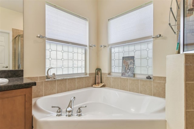 217 Sorrento Rd, Poinciana, FL 34759 - bathroom featuring vanity, a garden tub, and tiled shower