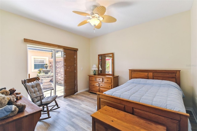 217 Sorrento Rd, Poinciana, FL 34759 - bedroom featuring access to outside, light wood-style flooring, and a ceiling fan