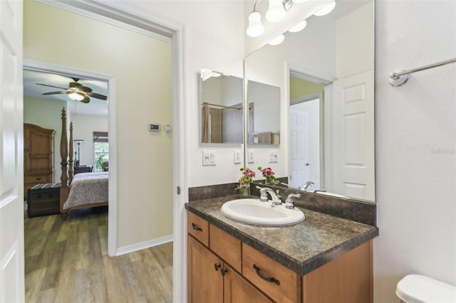 217 Sorrento Rd, Poinciana, FL 34759 - ensuite bathroom with wood finished floors, vanity, and a ceiling fan
